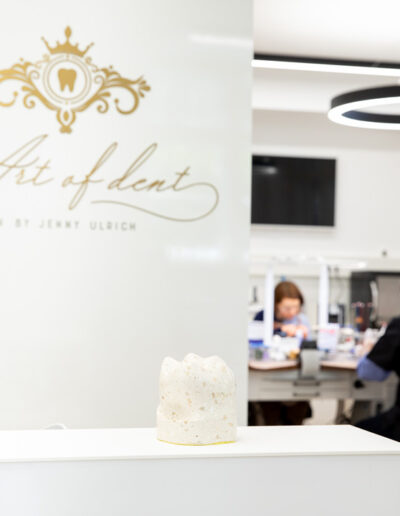 Jenny Ulrich steht einladend im Eingangsbereich von Art of Dent